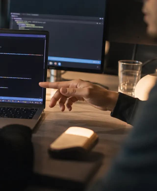 A close view of a code review on a laptop in warm light