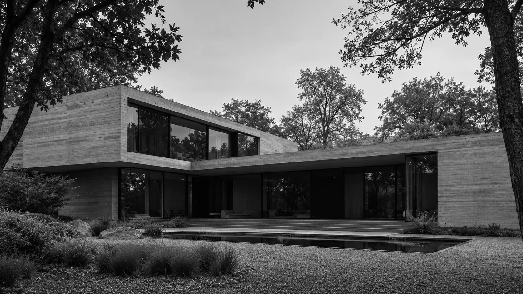 Architectural illustration from VEYR: a concrete house framed by trees in black and white